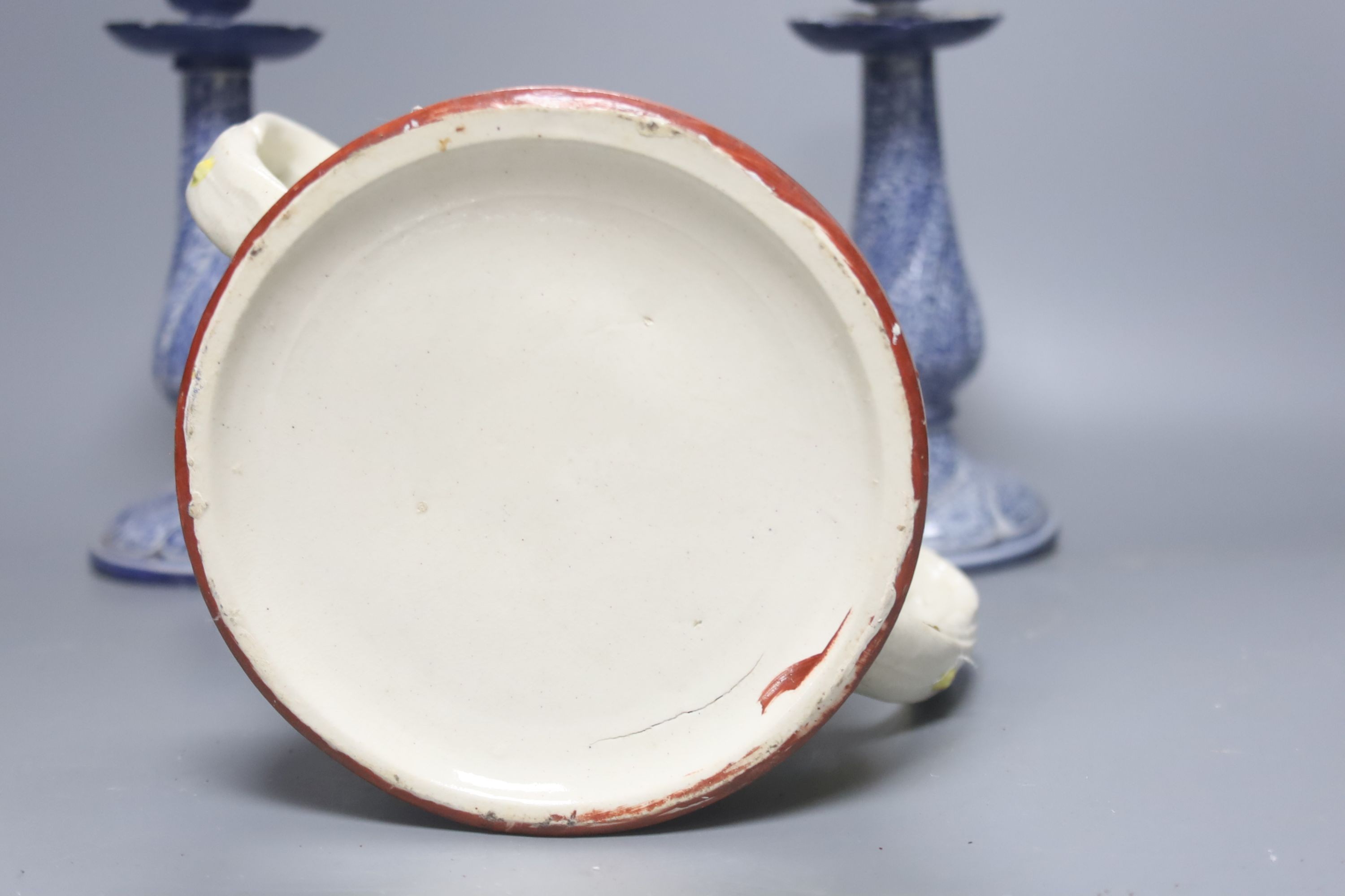 A Staffordshire pottery ‘duck’ tureen and cover, 23cm, a pair of faience candlesticks, Staffordshire figures of dogs, sheep and a zebra and a two handled loving mug